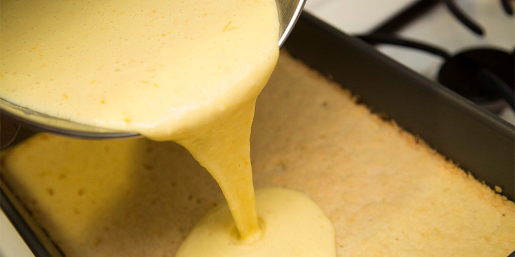 Pouring the lemon batter into the baking pan.