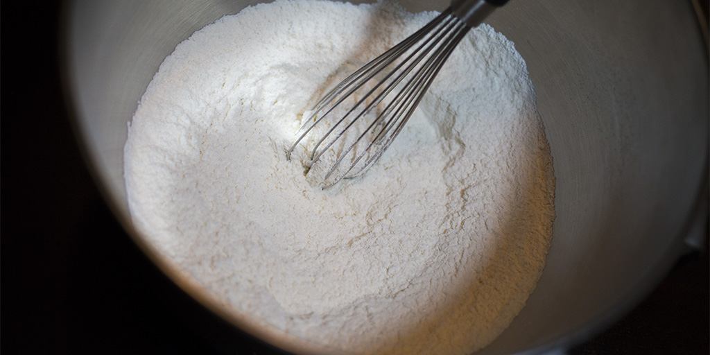 Mixing sugar, flour, and salt.