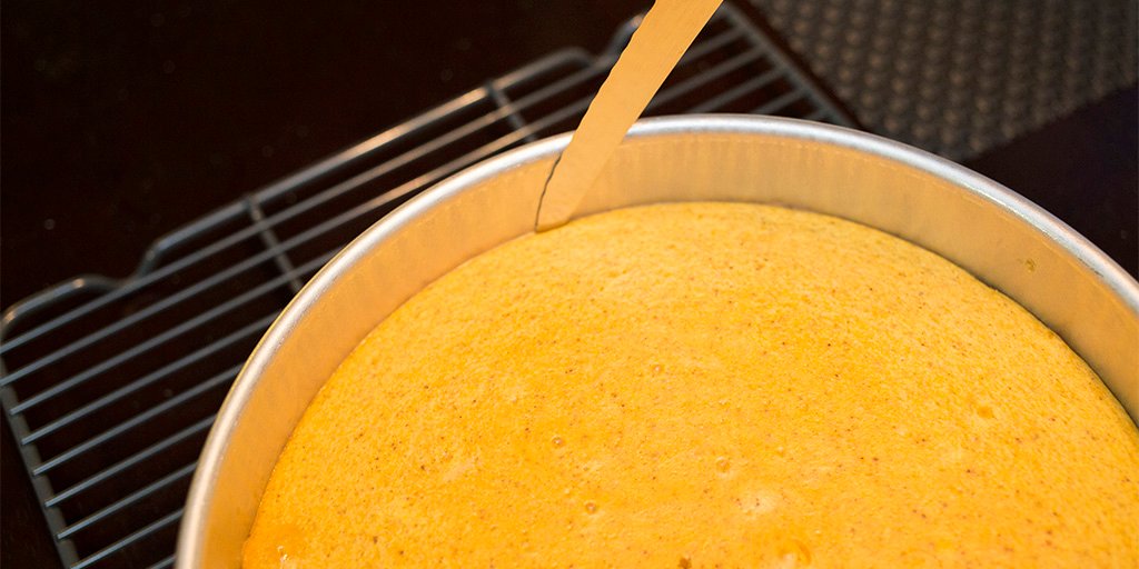 Running a knife around the edge of the cheesecake.